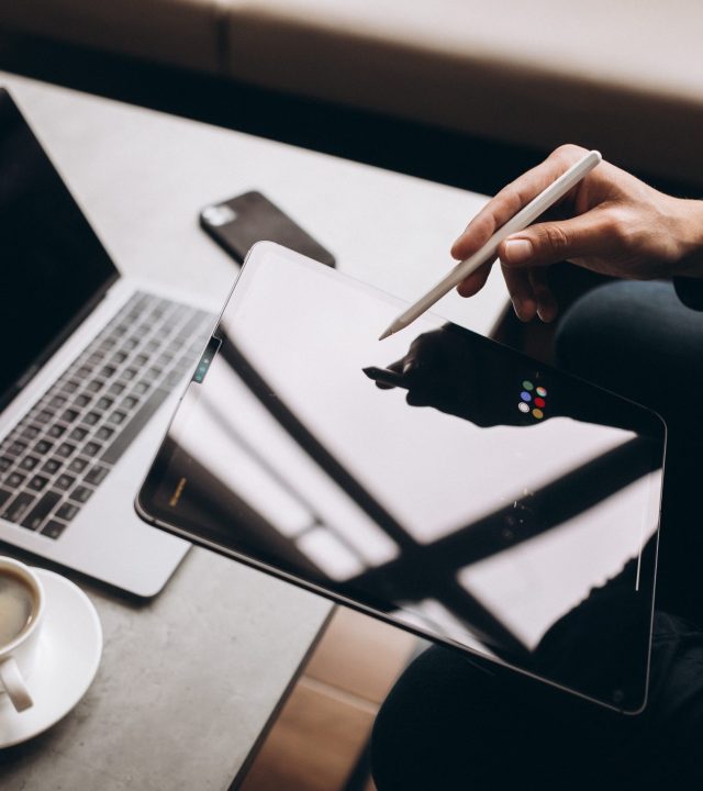 Man working on tablet close up at the table